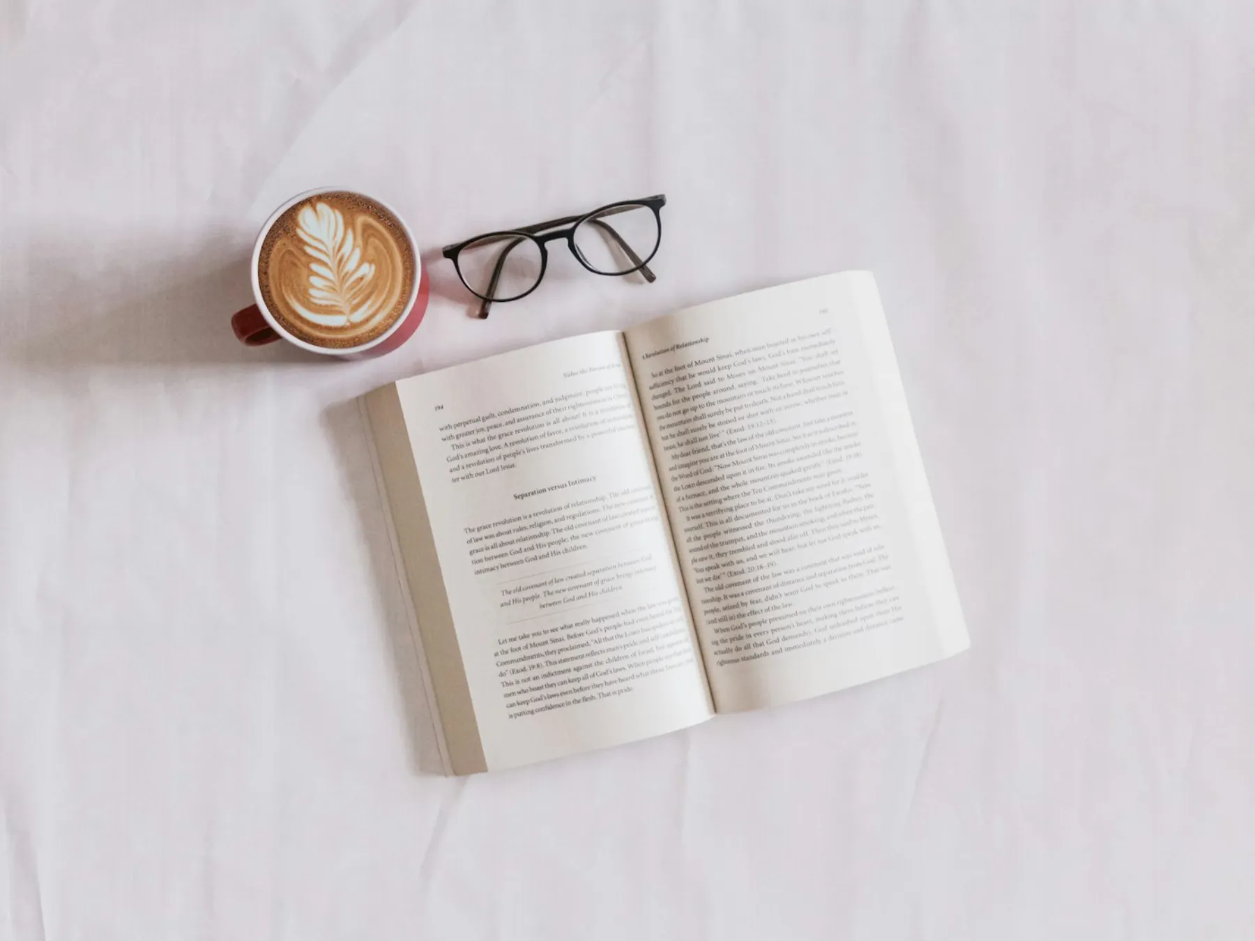 Journal, glasses and coffee laid out for a quiet reflective moment
